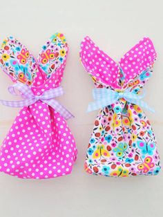 two bags with bows on them sitting next to each other