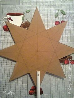 a paper star with coffee cups and cherries on it, cut out to look like an origami