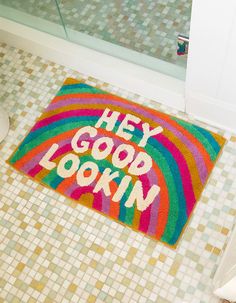 a bathroom rug with the words hey good looking on it