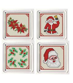 four cross stitch coasters with santa claus and holly decorations on the front, set of 4