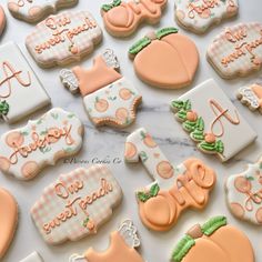 many decorated cookies are arranged on a marble counter top with the words sweet as peaches