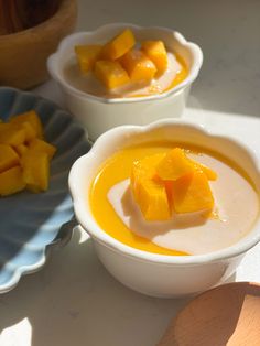 two bowls filled with food sitting on top of a table