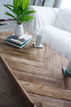 a coffee table with some books and a potted plant sitting on top of it