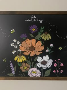 a chalkboard with flowers painted on it in front of a black background that says let's catch a bug