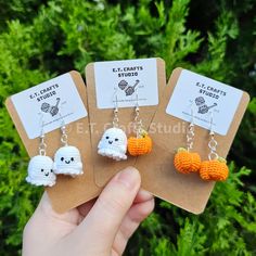 three small crocheted halloween earrings with pumpkins on them