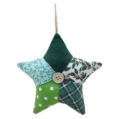 a green and white star ornament hanging from a string