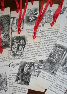 four bookmarks with red ribbons hanging from them