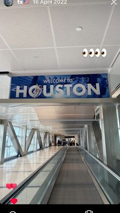 an escalator with a sign that says welcome to houston