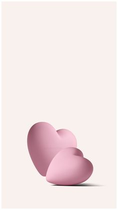 three pink heart shapes on a white background