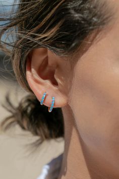 The prettiest blue opal hoops to sweeten your earlobes. These gold and cerulean blue opal huggie hoops shimmy and dance in the light day and night. Team them with with each other or mix and match with our other favorite hoop earrings. ✦ Choose your pair from two different sizes ✦✦ DETAILS ✦✧ Name: Kehaulani (keh-HOU-lah-nee) - Dew from the sky.✧ You will receive 1 pair.✧ Size 1: 10.5 x 2.25mm thick; 8.25mm inner diameter.✧ Size 2: 12.5 x 2.25mm thick; 9.75mm inner diameter.✧ Gold Plated Sterling Blue Opal Earrings, Small Gold Hoop Earrings, Gemstone Hoop Earrings, Small Gold Hoops, Tiny Hoop Earrings, Cerulean Blue, Summer Earring, Opal Earrings, Huggie Hoop Earrings