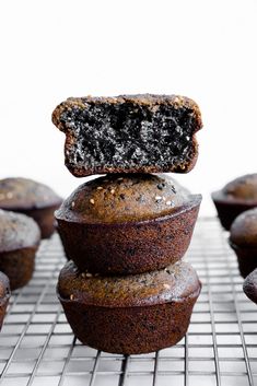 there is a chocolate cupcake on top of the muffins that are stacked up