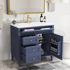 a bathroom vanity with two drawers and a mirror above it, next to a toilet