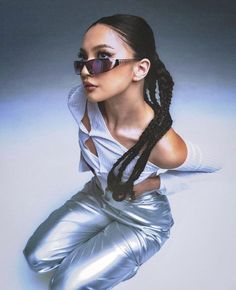 a woman in shiny silver pants and sunglasses