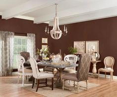 a dining room table with chairs and a chandelier