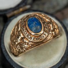 This awesome vintage West Point US Military Academy ring from 1961 features a lapis cabochon center stone. A personal engraving "with love Alan" remains visible. The ring has gentle overall wear, including some on the lapis, but is in great condition. The ring is currently a size 5. Luxury Heirloom Men's Cabochon Ring, Vintage Gold Sapphire Cabochon Ring, Vintage Gold Opal Ring With Polished Finish, Vintage Gold Sapphire Ring With Cabochon, Gold Vintage Sapphire Cabochon Ring, Vintage 14k Gold Sapphire Ring With Polished Finish, Vintage Gold Sapphire Ring With Polished Finish, Vintage Sapphire Ring With Oval Cabochon, Vintage 14k Gold Oval Cabochon Opal Ring