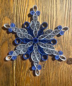 a paper snowflake sitting on top of a wooden table