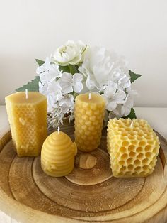 beeswax candles and flowers on a wooden tray