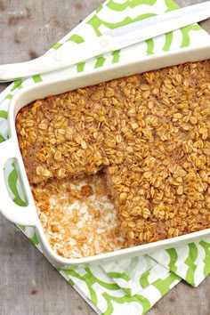 a casserole dish filled with oatmeal sitting on top of a green and white napkin