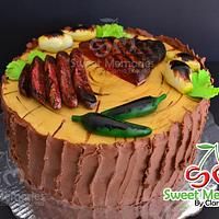 there is a cake that has been decorated with meats and vegetables on the top