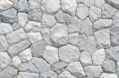 a stone wall that looks like it has been made out of rocks and is white