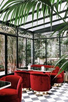 a room filled with lots of red couches and chairs