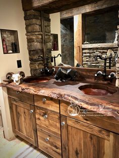 a rustic bathroom with double sinks and stone fireplace