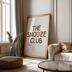 the snooze club sign is displayed in front of a white couch and coffee table