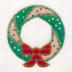 a christmas wreath with a red bow on it's front and green trim around the edges