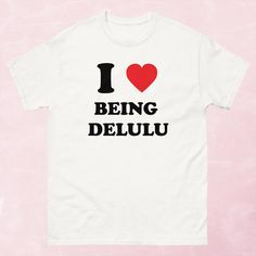 "Elevate your style with this empowering Women's T-Shirt that features the trendy phrase, \"I Love Being Delulu.\" Crafted for the modern woman, this tee is all about embracing self-love and celebrating individuality. It's a powerful statement of positivity that will boost your confidence every day. Premium comfort and durability A versatile addition to your casual wardrobe Available in various women's sizes for a perfect fit Easy care: Machine wash cold, tumble dry low Wear your self-love and empowerment proudly with this unique tee! This Women's T-Shirt is perfect for those seeking an inspirational and confidence-boosting fashion statement. It's designed to capture the attention of women who appreciate positive affirmations and unique, feminine graphic tees. Get yours today to make a str Being Delulu, Boost Your Confidence, Positive Affirmation, Casual Wardrobe, Positive Affirmations, Modern Woman, Women Empowerment, Self Love, Graphic Tee