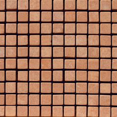 a close up view of a brick wall with small square tiles on the top and bottom