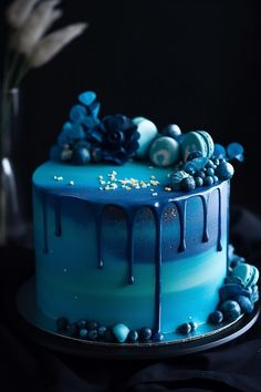 a blue cake sitting on top of a table