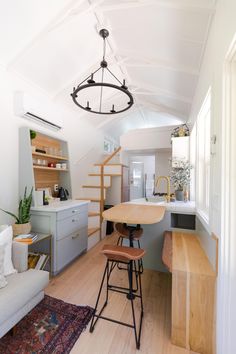 a kitchen and living room with stairs leading up to the loft