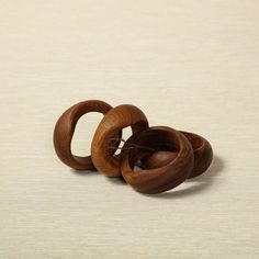 three wooden rings are sitting on the floor