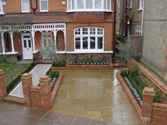 a large brick house with a fountain in the front yard