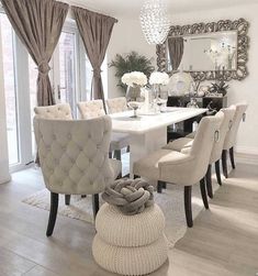 a dining room table with chairs and a chandelier