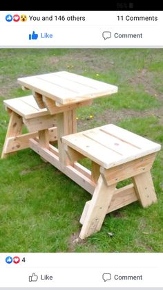 two wooden picnic tables sitting in the grass