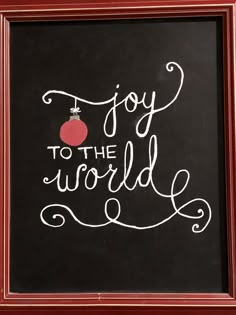 a chalkboard with the words joy to the world written in white lettering on it