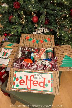 a christmas tree is decorated with boxes and candy