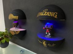 the wall is decorated with three different sports themed hats and figurines on it