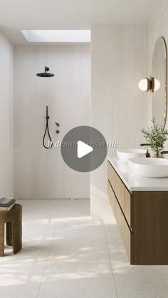 a bathroom with two sinks and a large mirror on the wall next to a walk in shower