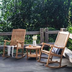 two rocking chairs and a table on a deck