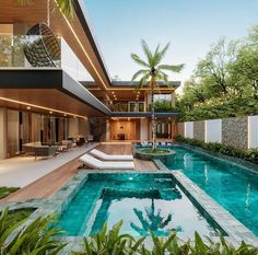 an outdoor swimming pool in front of a modern house with trees and plants around it