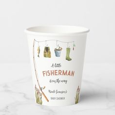 a paper cup with fishing related items on it