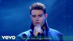 a young man holding a microphone in front of a blue background with the words i am the voice of sport history