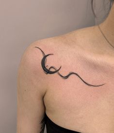 a woman with a tattoo on her shoulder