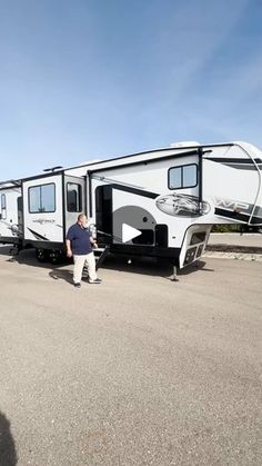 a man standing next to an rv on the road