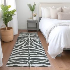 a bedroom with a zebra rug on the floor next to a bed and nightstands