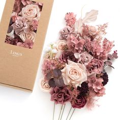 a bouquet of pink and white flowers next to a brown box with the words lings written on it