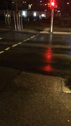 a red traffic light sitting on the side of a road