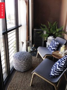 a living room filled with furniture and a large window covered in blinds next to a potted plant